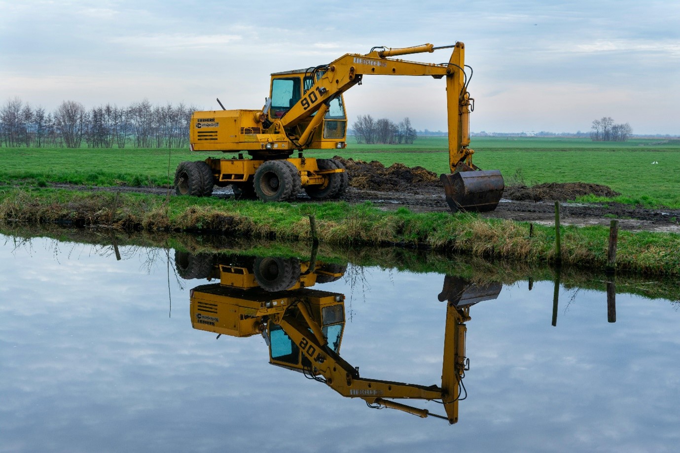 Indicative image of a digger on site to excavate land for an archaeological trial trench.